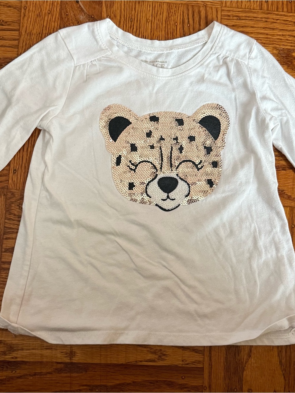 Place White Long-Sleeve Top with Gold Sequin Cheetah Face